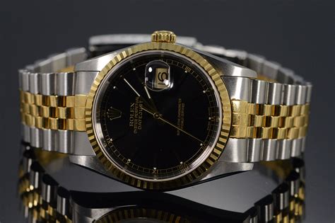 rolex oyster perpetual old black face silver gold band